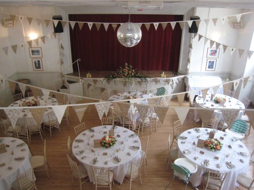 (57) The stage (behind the red curtains) can also be used for the top table. image